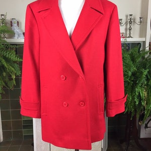 May include: A vibrant red double-breasted coat with a classic design. The coat features a notched collar, two rows of buttons, and a tailored fit. The sleeves have buttoned cuffs, and the coat has two front pockets. A timeless outerwear piece.