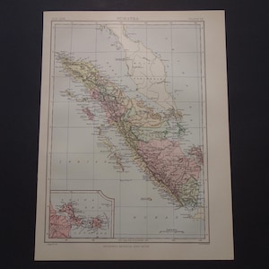 May include: A vintage map of Sumatra printed on off-white paper with black grid lines and text. The map features pastel-coloured regions, including pink, yellow, and green, with a smaller inset map of the China Sea in the bottom left corner.