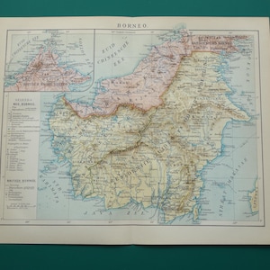 May include: A vintage map of Borneo, featuring detailed geographical information. The map is printed on aged paper, with a color palette of beige, brown, and blue. Text includes the word "BORNEO" at the top and other place names. The map is folded.