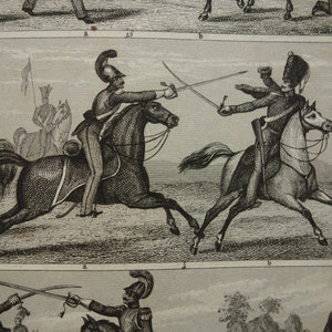 May include: An antique black and white print depicting cavalry soldiers on horseback engaged in sword combat. The illustration shows detailed uniforms and equipment, with figures in action. The scene is set in a field, with additional soldiers and a flag in the background.