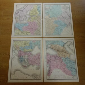 May include: Four antique maps of Europe, each framed in a white border. The maps feature detailed geographical information with pastel colors, including pink, blue, yellow, and green, depicting various regions and countries.