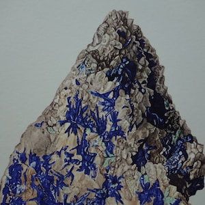 May include: A close-up of a mineral specimen featuring a rough, textured surface. The stone is primarily beige and gray, with vibrant blue crystalline formations throughout. The overall shape is triangular, with a light gray background.