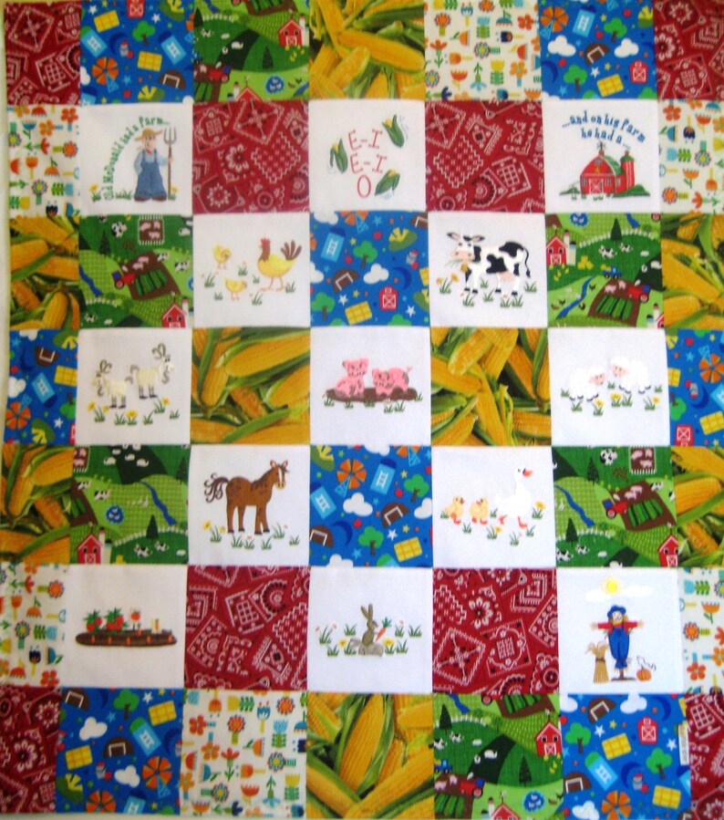 May include: A colorful patchwork quilt with a farm theme. The quilt is made up of squares with different images, including a farm, animals, and corn. The quilt is white with red, blue, green, and yellow accents. The text "E-I E-I O" is embroidered on one of the squares.