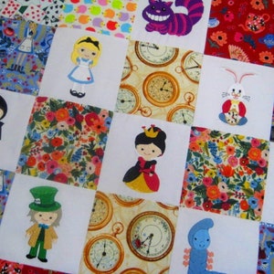 May include: A patchwork quilt with a white background and colorful squares featuring characters from Alice in Wonderland. The characters include Alice, the Mad Hatter, the Queen of Hearts, the Cheshire Cat, the White Rabbit, and the Queen of Hearts. The squares are surrounded by a border of colorful floral fabric.