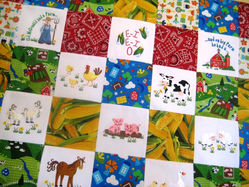 May include: A colorful quilt with a farm theme. The quilt is made up of squares with different images, including a red barn, a cow, corn, a rooster, and a pig. The quilt is perfect for a child's room or nursery.