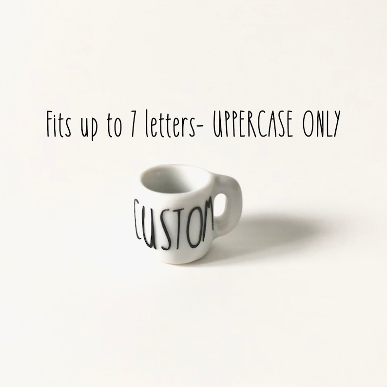May include: White ceramic mug with a black "CUSTOM" inscription. Fits up to 7 letters - UPPERCASE ONLY.