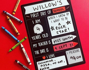 May include: Black chalkboard with white text and a red heart. The text reads "WILLOW'S FIRST DAY OF SCHOOL I AM 4 YEARS OLD MY TEACHER IS THE DATE IS WHEN I GROW UP I WANT TO BE A ROCK STAR! MISS SMITH 9 SEPT '21 I LOVE SWIMMING, PIZZA, MY CAT, BMTH I MEASURE 94CM".