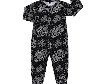 May include: Black long-sleeved baby sleeper with a white floral print of roses and stars.