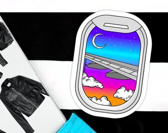 May include: A sticker of an airplane window with a view of a colorful sunset and a crescent moon in the sky. The window is outlined in black and the sticker is white.