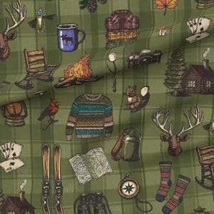 May include: A green fabric featuring a repeating pattern of outdoor-themed illustrations including log cabins, deer heads, skis, campfires, rocking chairs, sweaters, lanterns, binoculars, playing cards, maps, pine trees, and colorful socks.