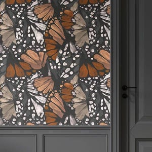 May include: Wallpaper featuring a repeating pattern of butterflies in shades of brown, tan, and white against a dark gray background. The butterflies are detailed with intricate wing patterns. The wallpaper is installed on a wall with dark gray trim.