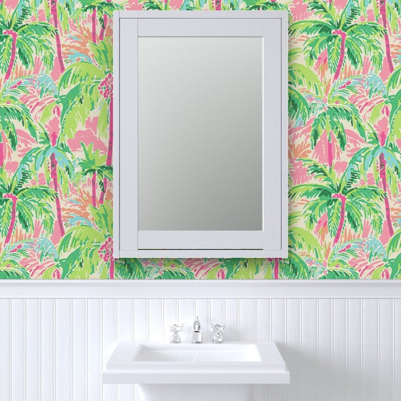a bathroom with a palm tree wallpaper and a mirror