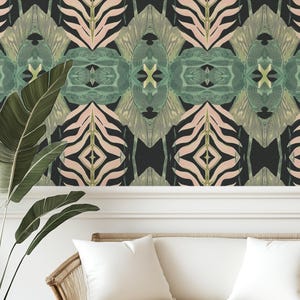 May include: A black, pink, and green wallpaper with a geometric pattern featuring zebra stripes and tropical leaves. The wallpaper is displayed on a wall with white trim and a white couch in front of it.