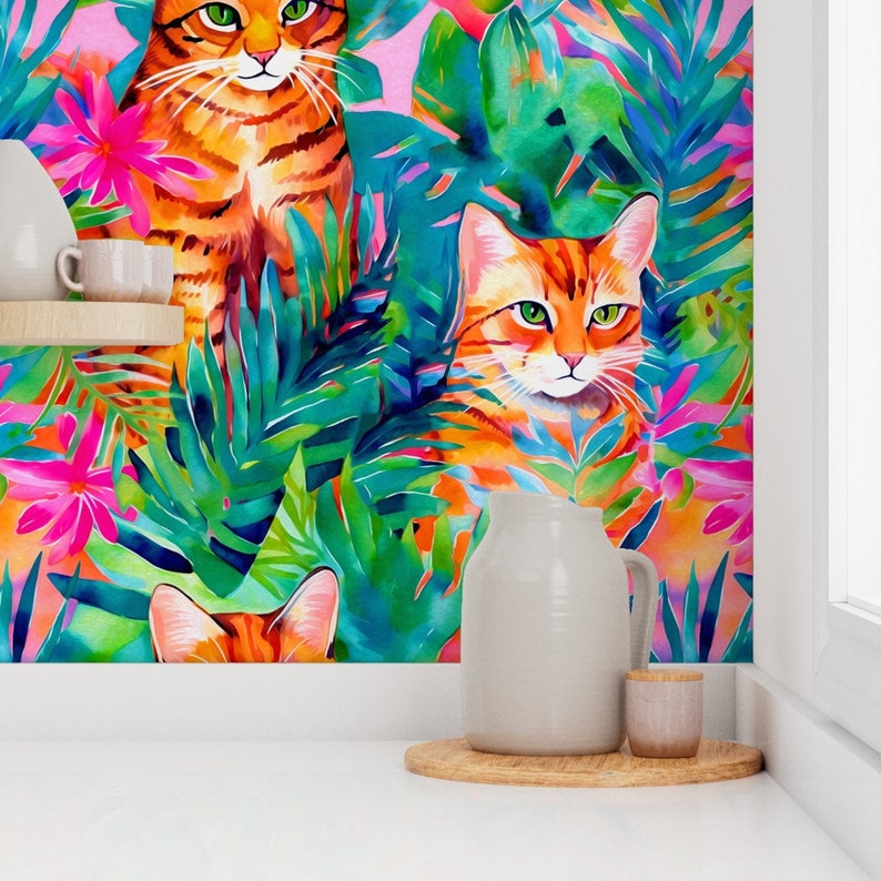 May include: Three orange tabby cats with green eyes are peeking out from behind lush tropical foliage. The background is a vibrant mix of pink, blue, and green.