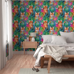 May include: A bedroom with a white bed and a wooden nightstand. The walls are covered in wallpaper with a pattern of orange cats and tropical plants in shades of green, pink, and blue.