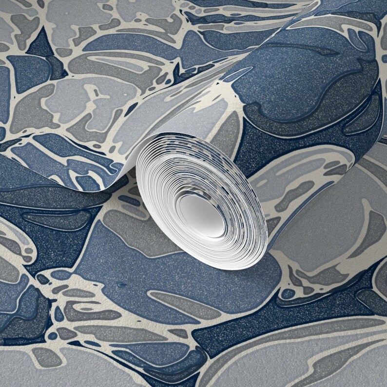 a roll of blue and white wallpaper on a wall