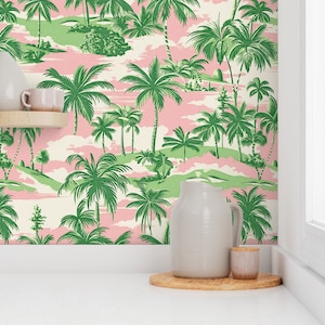 May include: Pink and green tropical wallpaper with palm trees and clouds. The wallpaper is in a kitchen setting with a white pitcher and a small jar on a wooden surface.