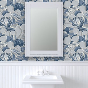 a white sink sitting under a bathroom mirror