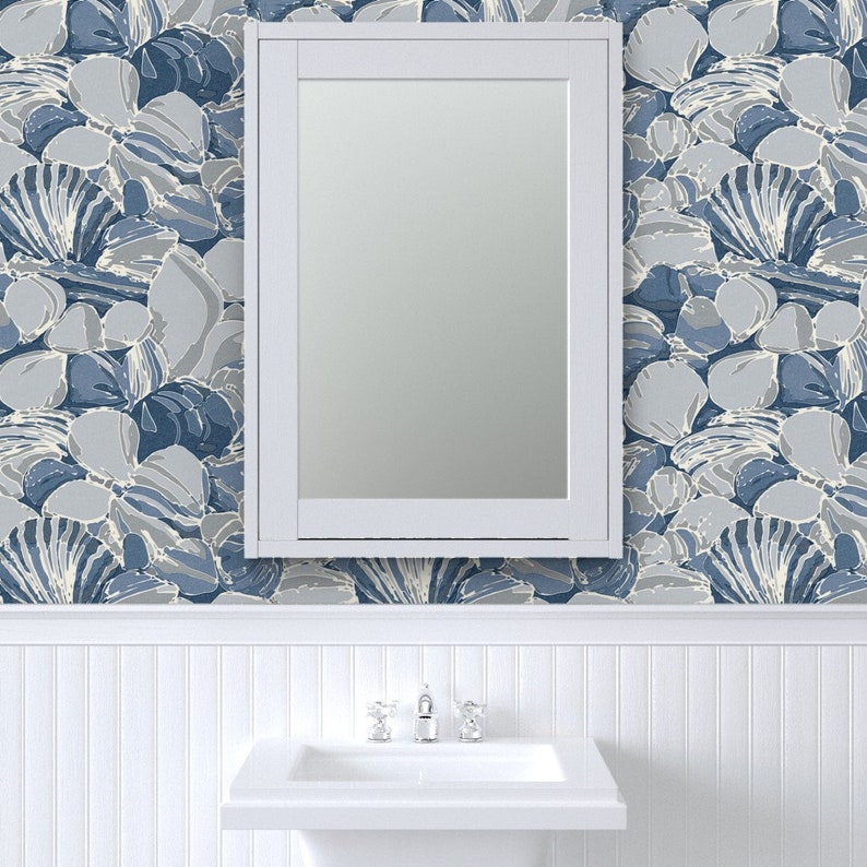 a white sink sitting under a bathroom mirror