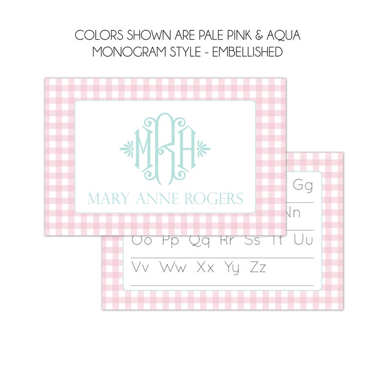 May include: A pink and white gingham card with a light blue monogram "MRA" and the text "MARY ANNE ROGERS". The card is for practicing writing the alphabet, with dotted lines for each letter.