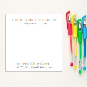 May include: A white note card with the text "a note from the mom of" followed by two checkboxes, one labeled "Merry McCollum" and the other labeled "Tee". Below the checkboxes is the text "meredith roberts" and the contact information "601.555.2345 | MeredithRob@yahoo.com".