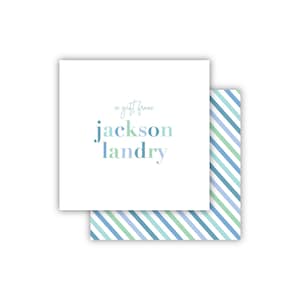 May include: A white gift tag with blue and green stripes on the back. The tag says "a gift from jackson landry" in blue, green, and purple lettering.