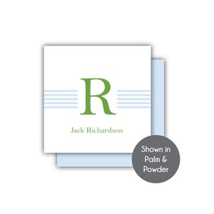 May include: A white card with a green letter "R" and blue stripes. The text "Jack Richardson" is printed below the letter. The card is shown in Palm & Powder.