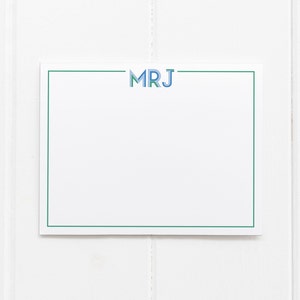 May include: A white card with a green border and the text "MRJ" in blue and green letters.