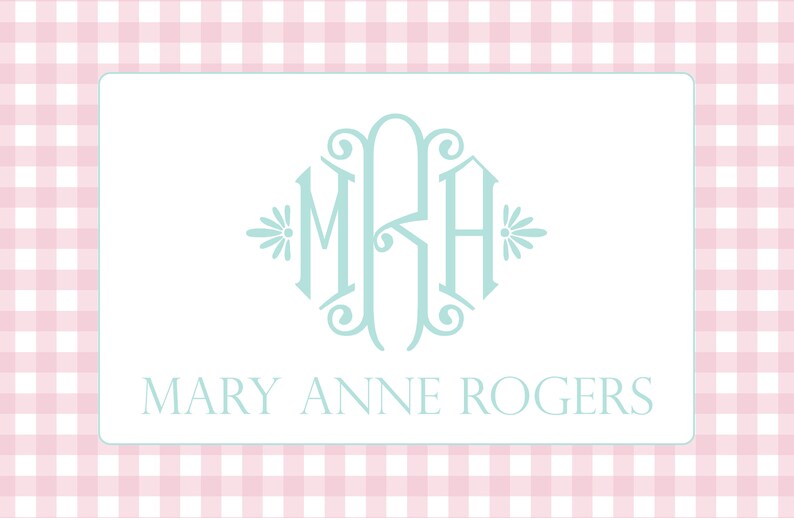 May include: A white card with a light blue monogram of the letters "MRH" in a decorative font. The letters are surrounded by a decorative border with floral accents. Below the monogram, the text "MARY ANNE ROGERS" is printed in a simple font.