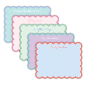 May include: A stack of personalized stationery cards in pastel colors. Each card has a scalloped edge and features a different name in a complementary color. The names include Elizabeth Anderson, Katherine James, Leighton Rogers, Sara Blair Williams, and Ashby Sanders.