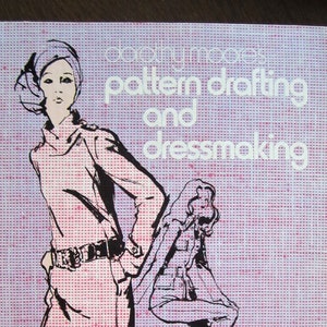 May include: A book cover with a pink and white patterned background. The title is "Dorothy Moore's Pattern Drafting and Dressmaking". Two women are illustrated in black and white on the cover.