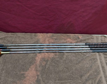 May include: Set of four vintage golf clubs with wooden heads and metal shafts. The clubs have a brown and black grip.