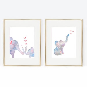 May include: Two watercolor paintings of elephants with pink hearts. The first painting shows a mother elephant and a baby elephant with hearts floating above them. The second painting shows a single elephant with hearts floating above its trunk.