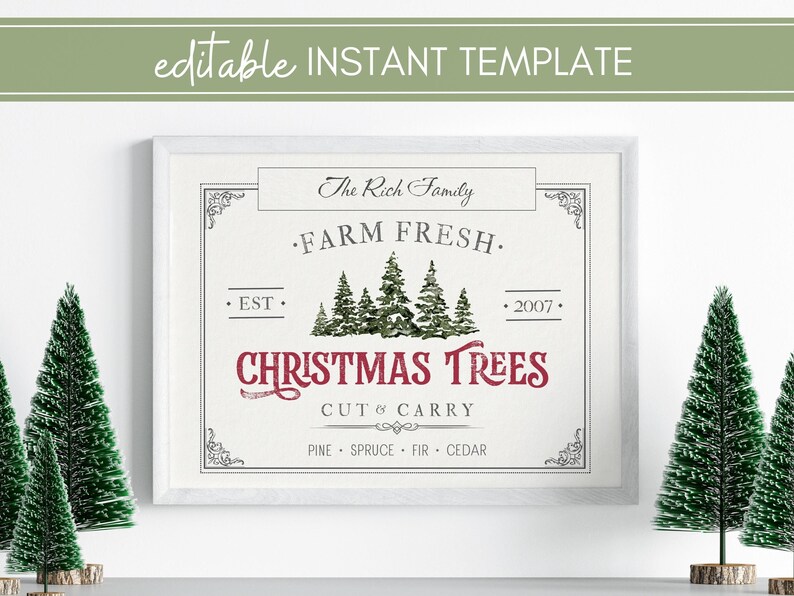 May include: A white framed sign with the text "The Rich Family Farm Fresh. Est. 2007. Christmas Trees Cut & Carry Pine Spruce Fir Cedar" in a vintage style font. The sign is on a white wall with two small green artificial Christmas trees on either side.