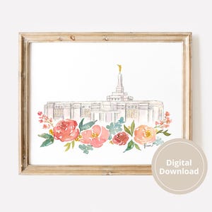 May include: Watercolor print of a white building with a gold statue on top, framed in a light wood. The building is surrounded by watercolor flowers in shades of pink, peach, and green. The words "Digital Download" are in a circle in the bottom right corner.