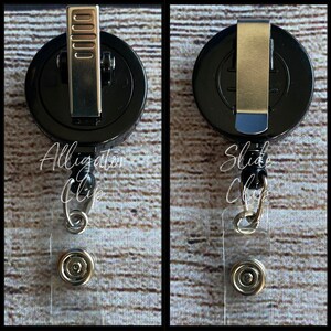May include: Black retractable badge reel with a clear plastic badge holder. The reel has a silver alligator clip on one side and a silver slide clip on the other side.