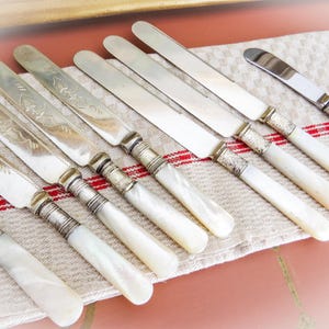 Antique Mother of Pearl Cutlery, 9 Pieces Silver Plate bands and blades, some marked, Set of 4, Set of 3, 2 fancy Butter Spreaders, Etched
