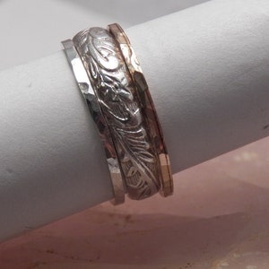 Sterling silver floral patterned band ring with sterling and 14 karat gold filled stackers