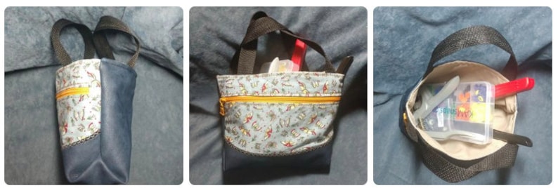 May include: A small, blue tote bag with a zipper closure and a patterned fabric lining. The bag has two black handles and is shown with various items inside, including a red pen, a white plastic container, and a blue and white card.