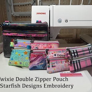 May include: A collection of Twixie double zipper pouches in various patterns, including stars, watercolor swirls, and plaid. The pouches are displayed in front of a sewing machine. The text "Twixie Double Zipper Pouch By Starfish Designs Embroidery" is visible.