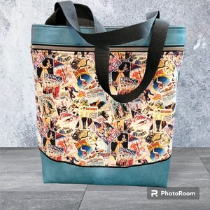 May include: A blue tote bag with black straps and a colorful print of vintage circus posters. The print features images of clowns, acrobats, and animals. The text on the posters includes "Alcazar" and "Tents Melinite".