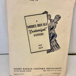 May include: A vintage Modes Royale sewing pattern envelope, No. 520, size 12. The off-white paper envelope features black text and a black-and-white illustration of a person in a dress. It includes the address for the Pattern Department in New York.