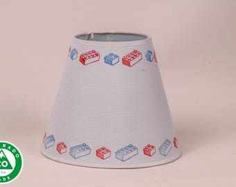 Small white lamp shade stamped with red and blue bricks