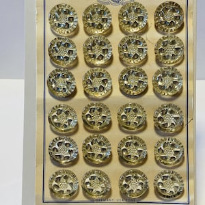 May include: A card of 20 clear glass buttons with a raised floral design. The card is labeled "Plus Ultra Reg'd Pat Off" and "Germany USA Zone".