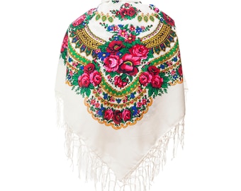 May include: White shawl with a floral pattern in shades of red, green, yellow, and blue. The shawl has a fringe border.