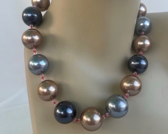 Variegated Shell Pearls hand knotted in red silk thread, 20 mm shell pearls, 3 mm Swarovski crystal with 14k GF findings and toggle