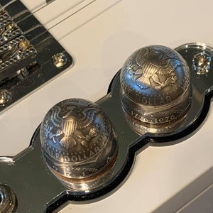 Domed Kennedy half dollar guitar knob.