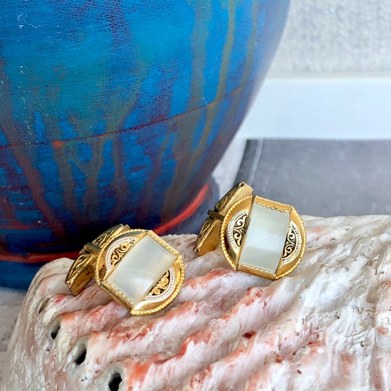 Damascene gold tone cuff links.