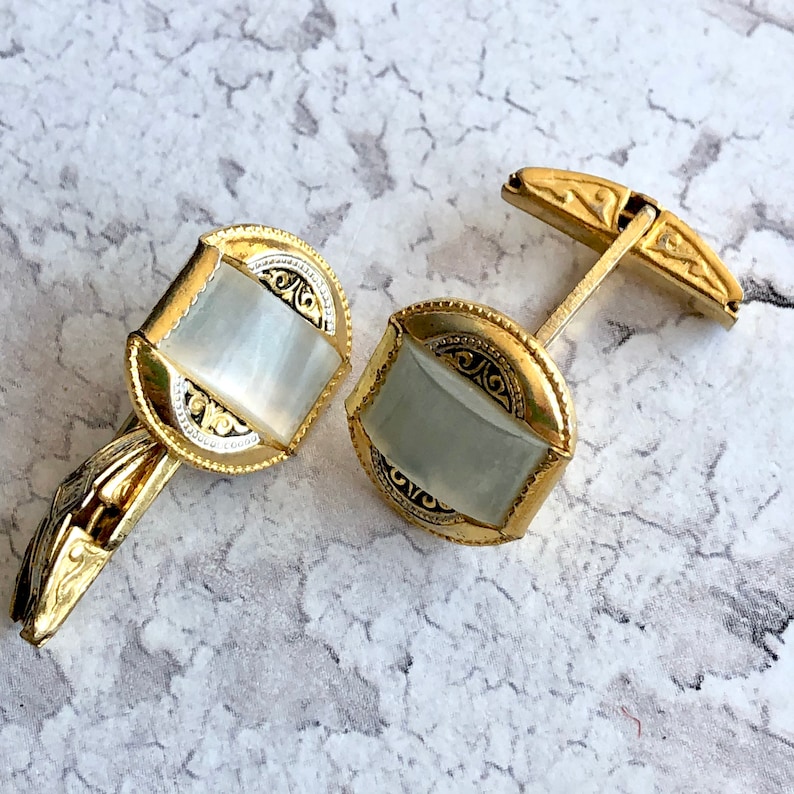 Damascene gold tone cuff links.