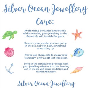 May include: A white card with blue text that reads "Silver Ocean Jewellery Care:" and provides instructions for caring for jewelry. The card is decorated with illustrations of a turtle, a starfish, a seashell, a fish, an anchor, and a seashell.